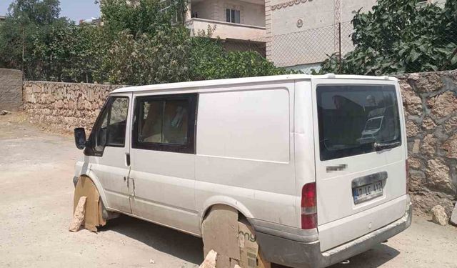 Mardin’de minibüs sürücüsü, aracın tekerlerini sıcaktan korumak için kartonla kapattı