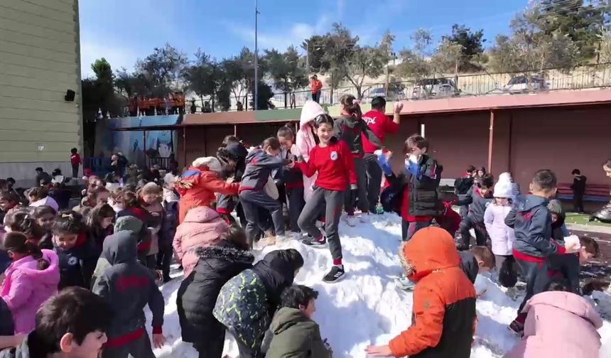 Kamyonla okul bahçesine taşınan kar, öğrencilerin neşe kaynağı oldu